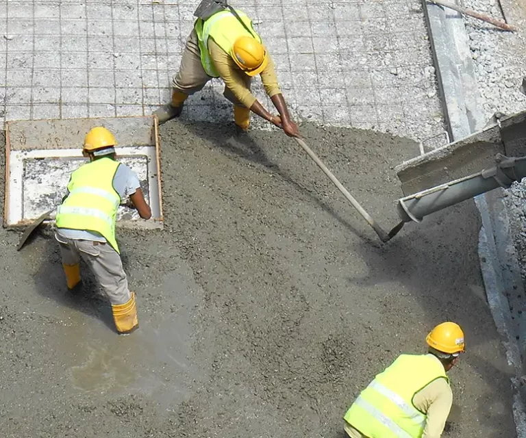 Workers Leveling Concrete Being Poured